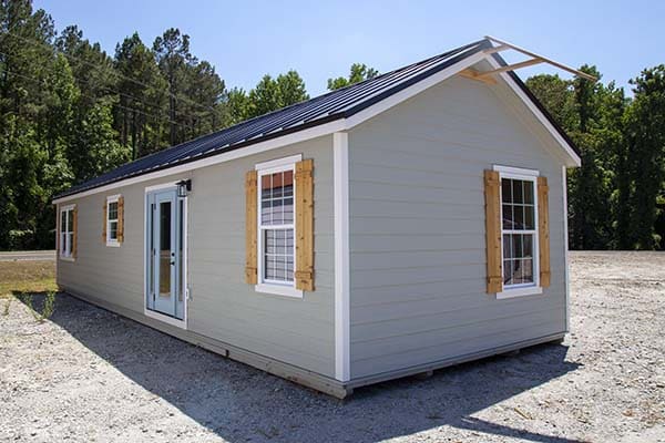 gray siding and wood accents on modular tiny home cabin
