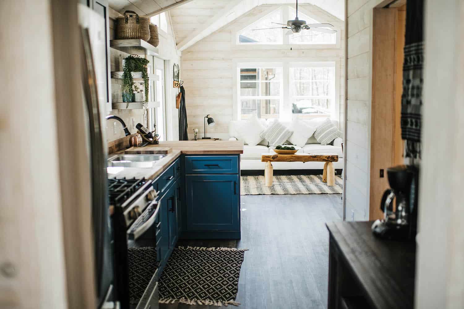 connected kitchen and living space layout in prefab cabin