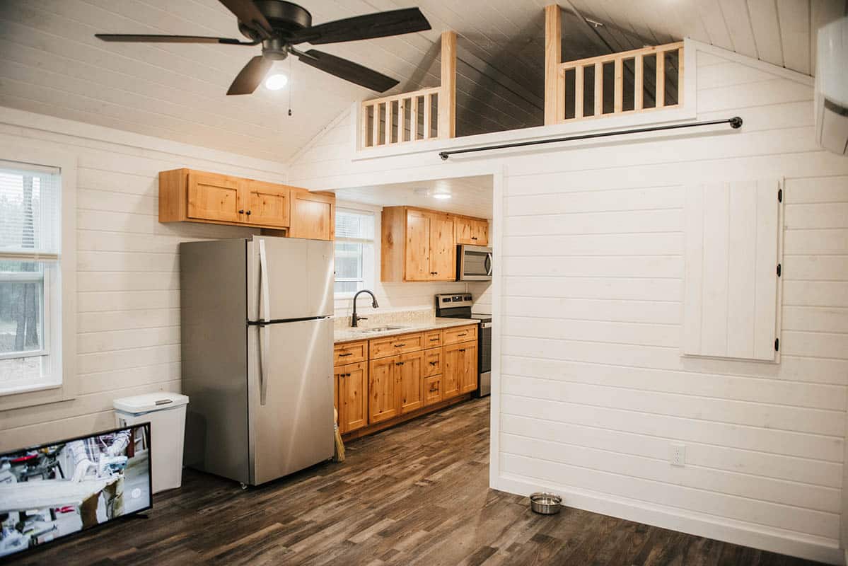 prefab log cabin tiny home kitchen and loft