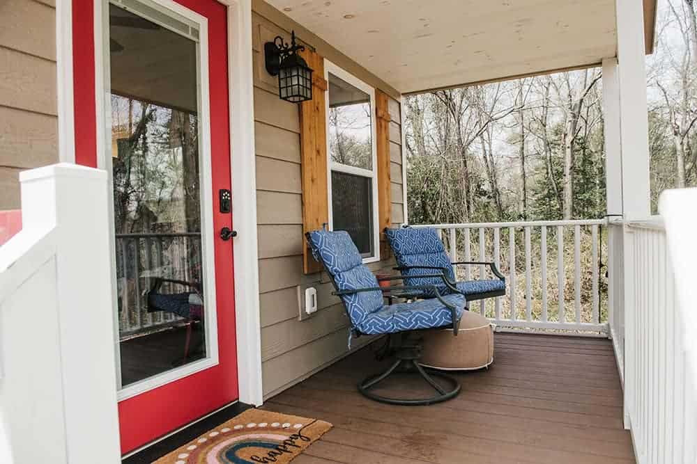 covered porch with white and tan accents on modular cabin