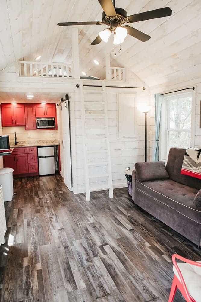 white modern cottage interior and red accents in prefab tiny cabin