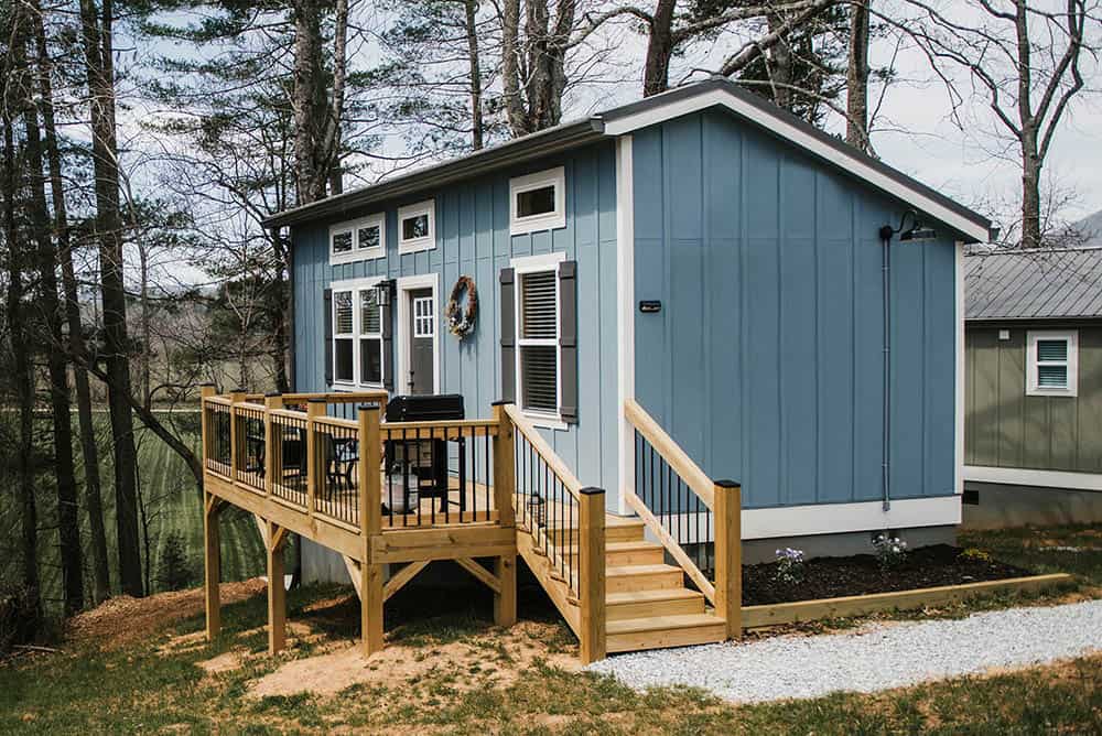 blue exterior on modular tiny home with wooden deck