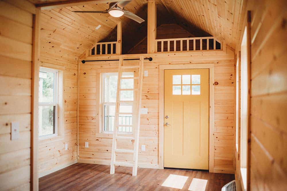 wooden interior entryway and loft space of modular tiny home