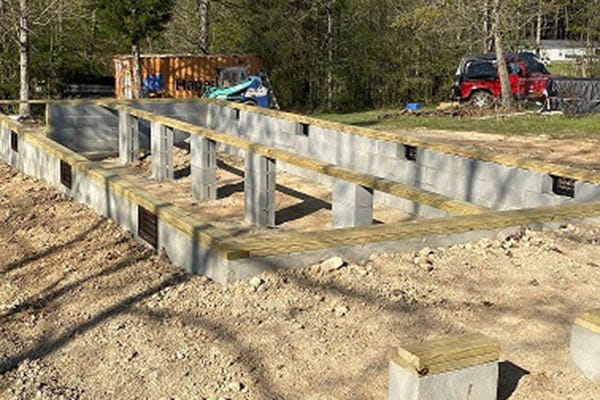 prefab log cabin foundation under construction
